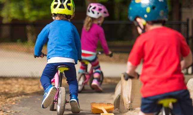 Toddlers on bikes outdoors